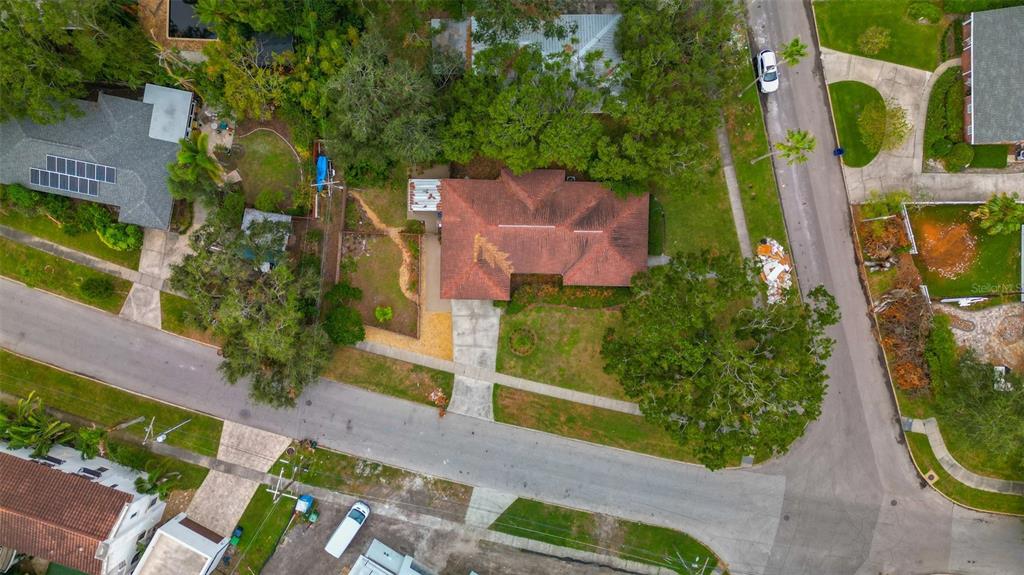 an aerial view of residential house with outdoor space and trees