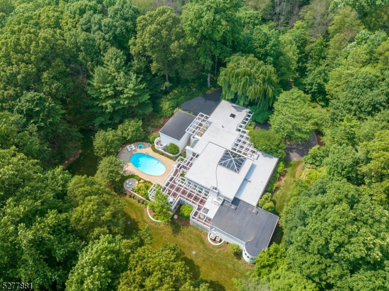 an aerial view of a house with yard swimming pool and outdoor seating