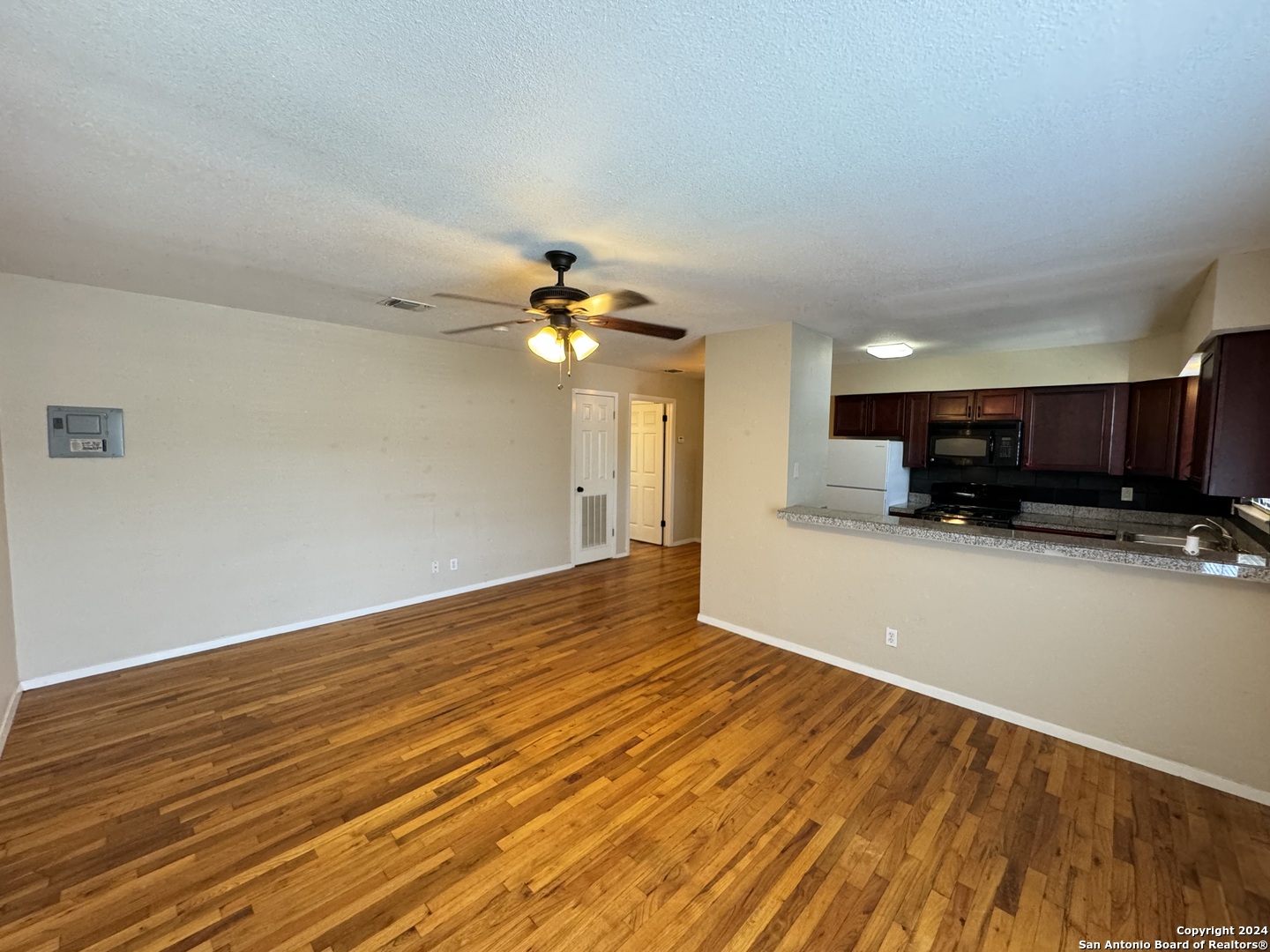 a view of a livingroom with furniture and an empty room