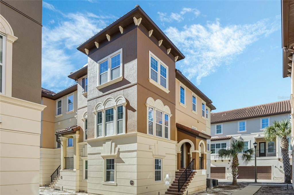 a front view of a residential apartment building with a yard