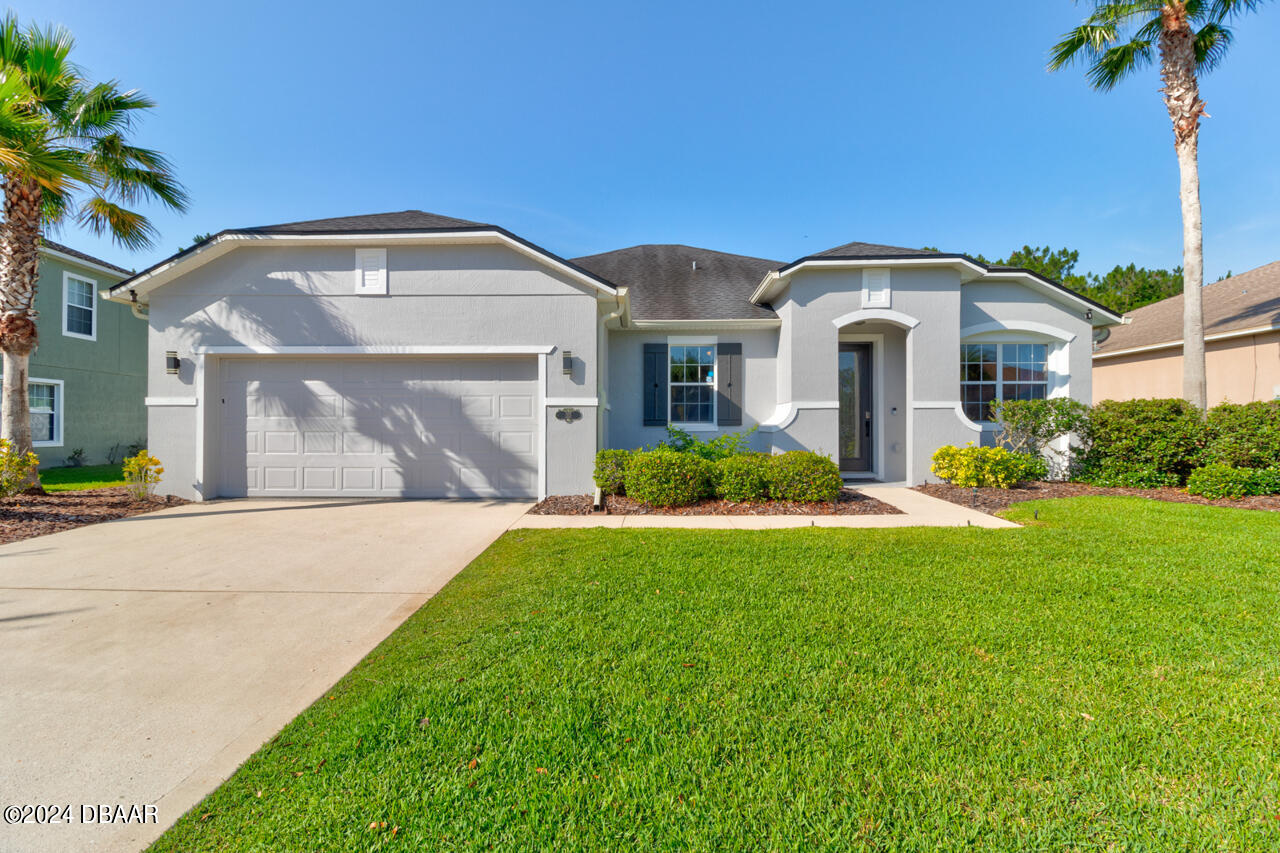 a front view of a house with a yard and garage