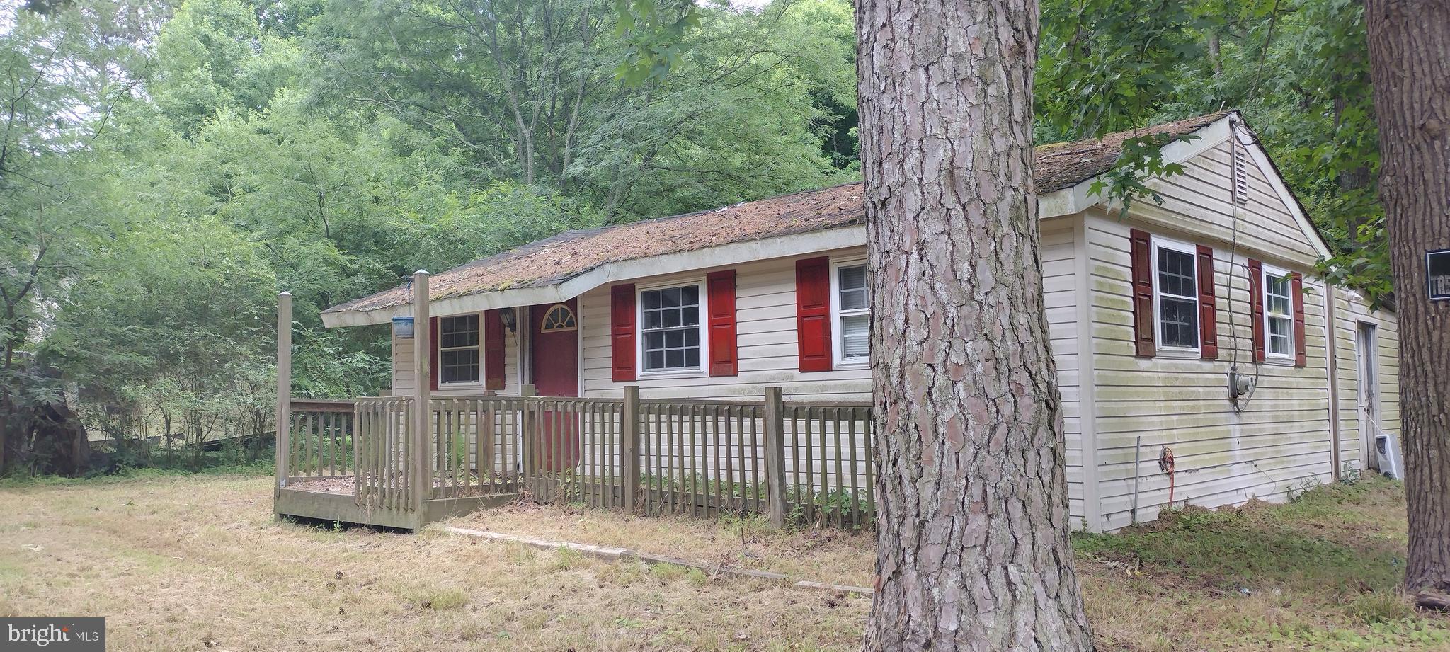 a view of a small house with a tree in the yard