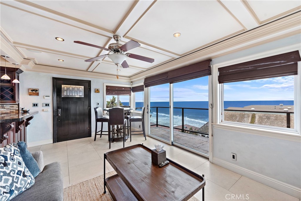 a living room with furniture a ceiling fan and a window