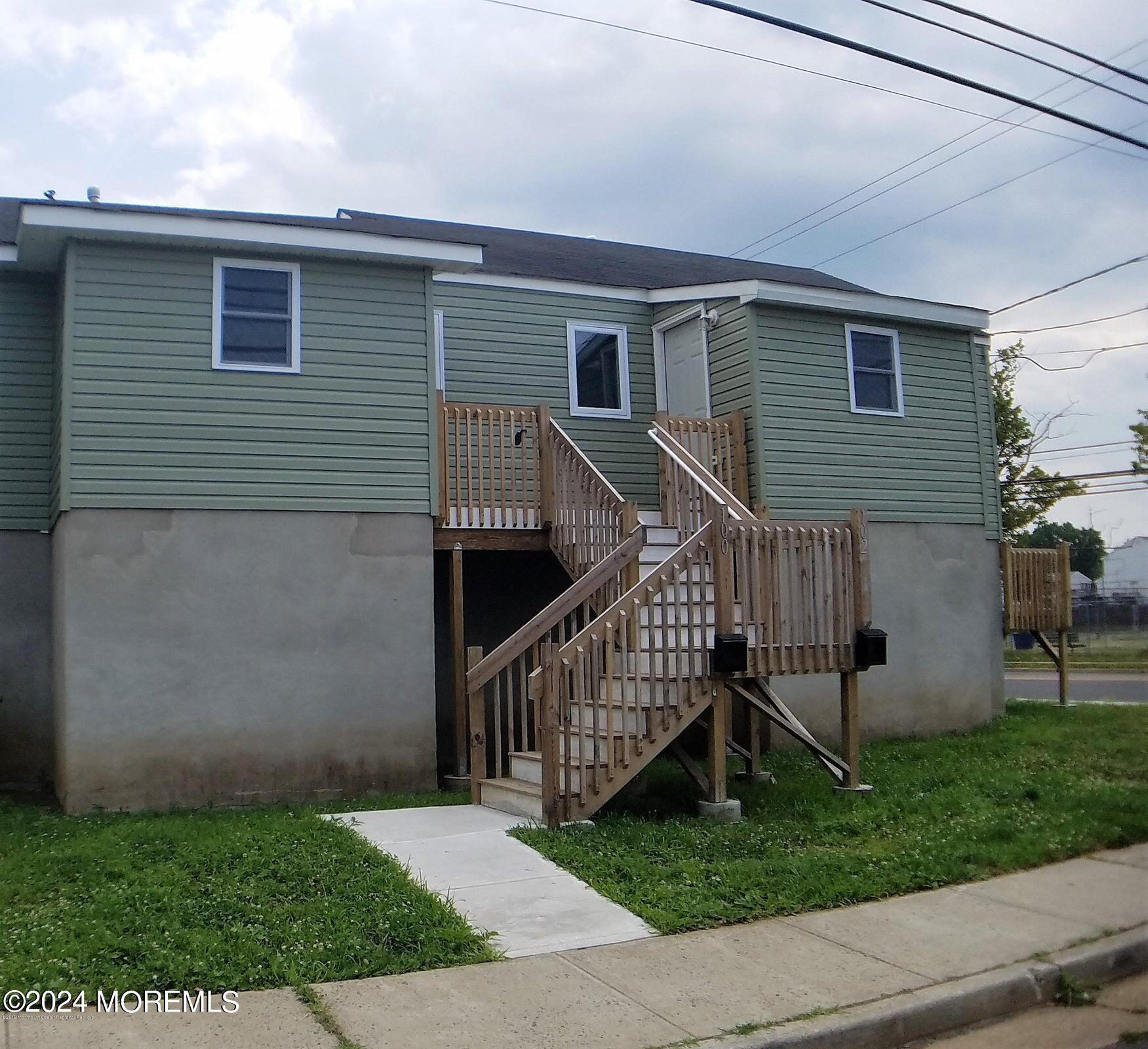 a view of backyard of house with deck