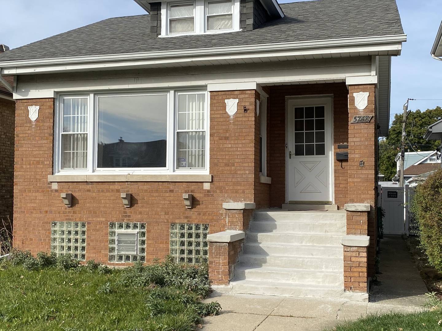 a front view of a house with a garden