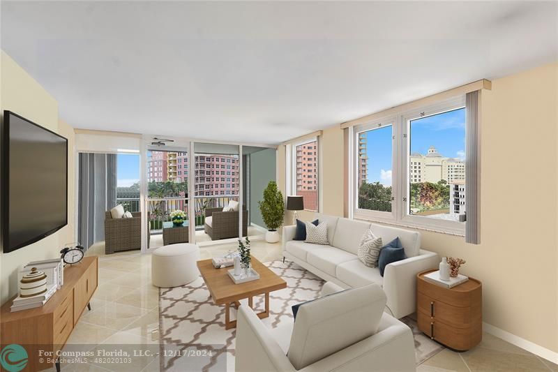 a living room with furniture a flat screen tv and a floor to ceiling window