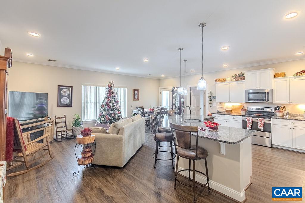 a living room with kitchen island furniture and a wooden floor