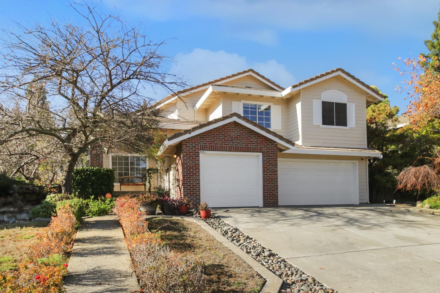 a view of a house with a yard and garage