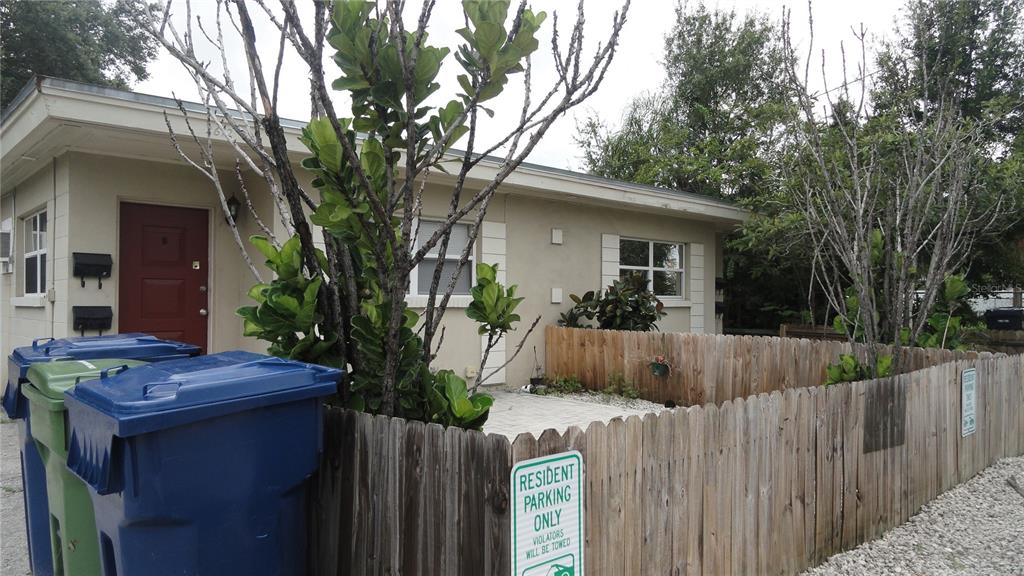 a view of a house with wooden fence