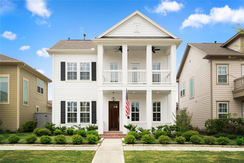 a front view of a brick house with a yard