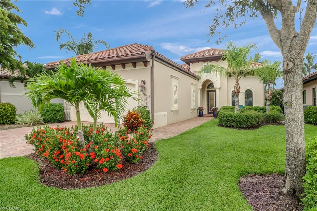 View of front of house with a garage and a front yard