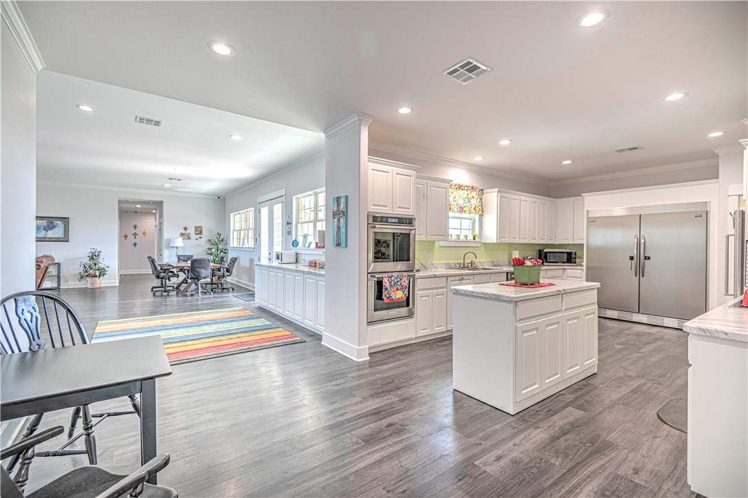 a view of kitchen with furniture and wooden floor