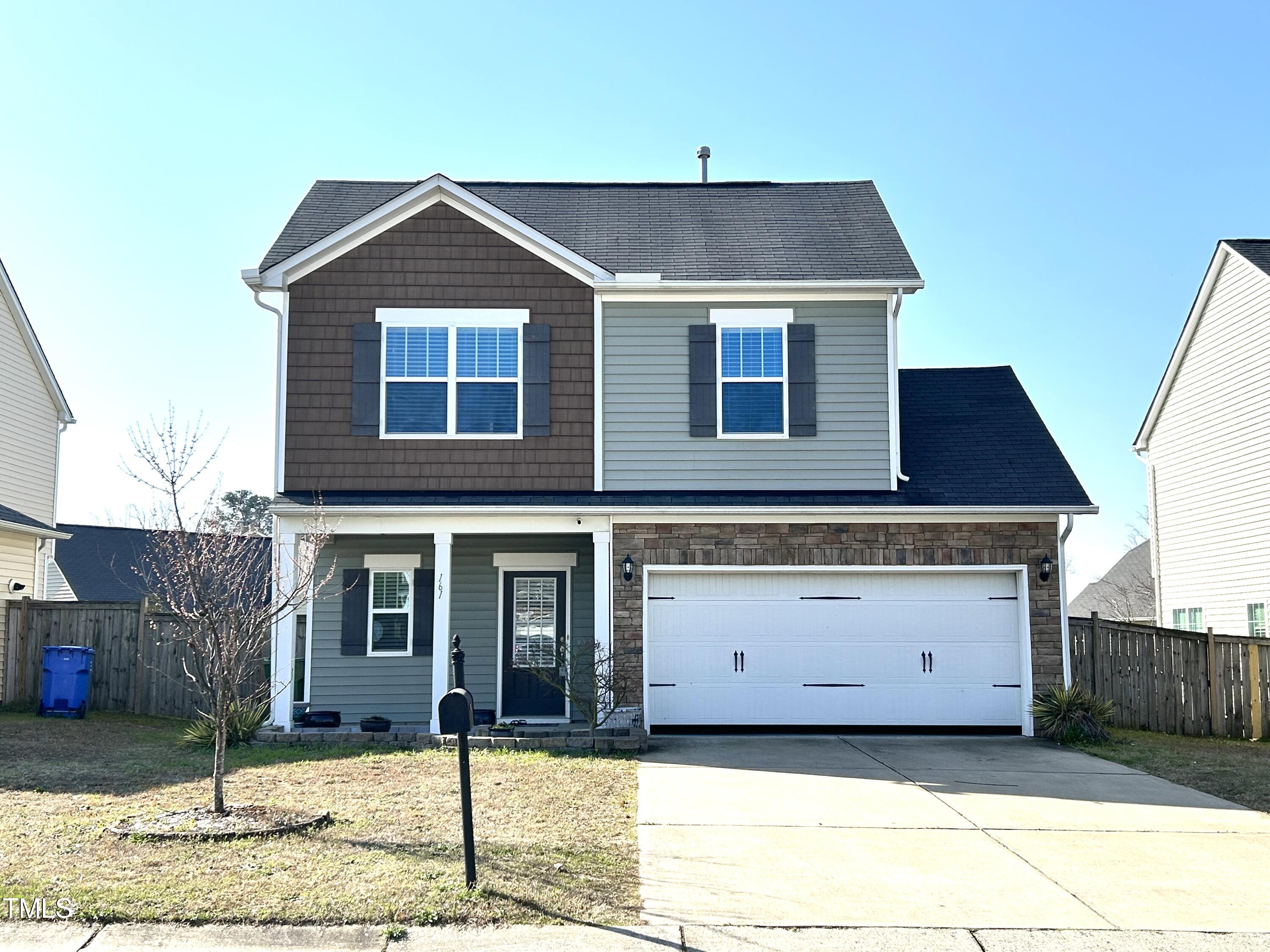 a front view of a house with garage