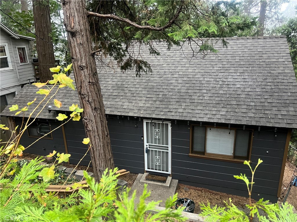 a view of house with a backyard