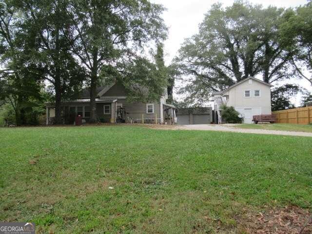 a front view of house with yard and green space