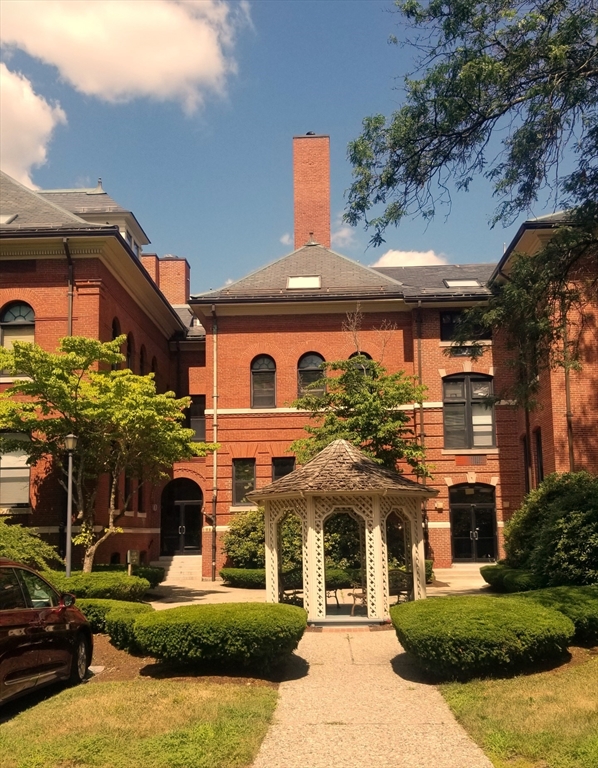 a front view of a building with a garden