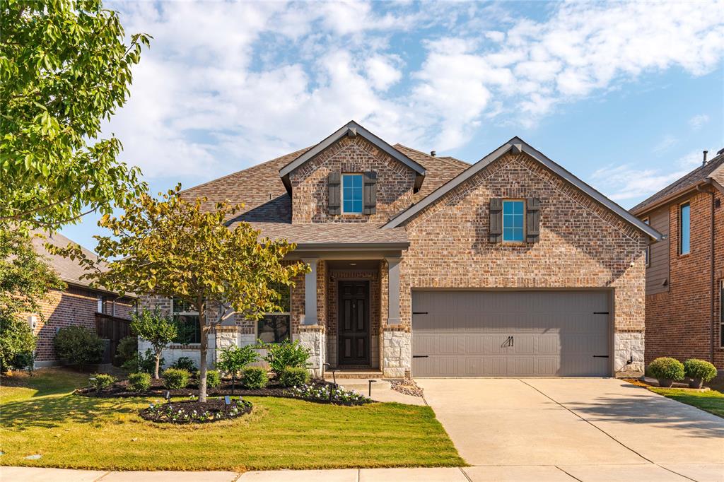 Craftsman-style house with a front yard and a garage