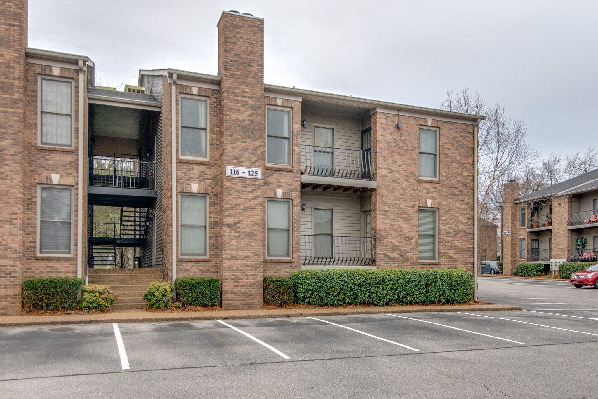 a view of a brick building next to a road