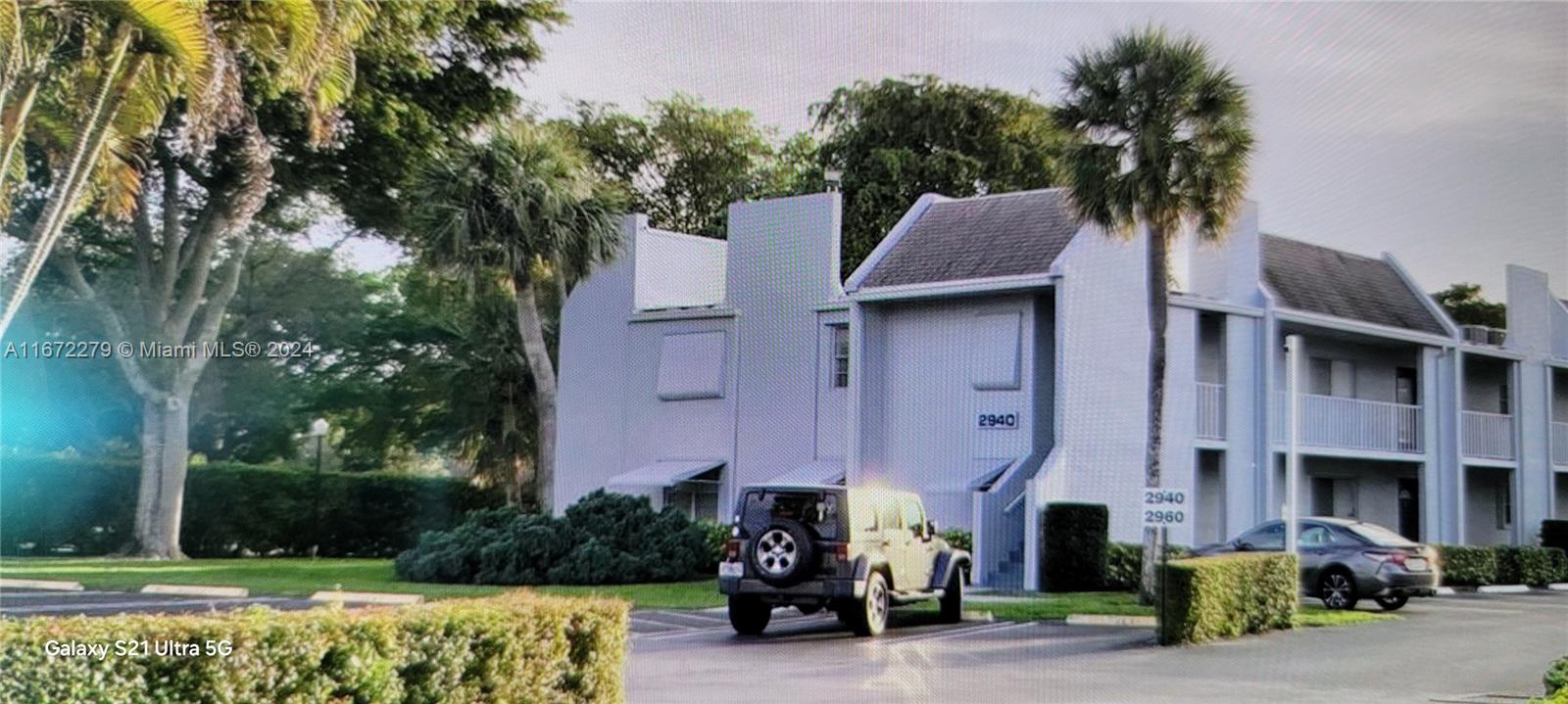 a front view of a house with a garden and plants