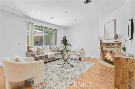 a living room with furniture a fireplace and a table