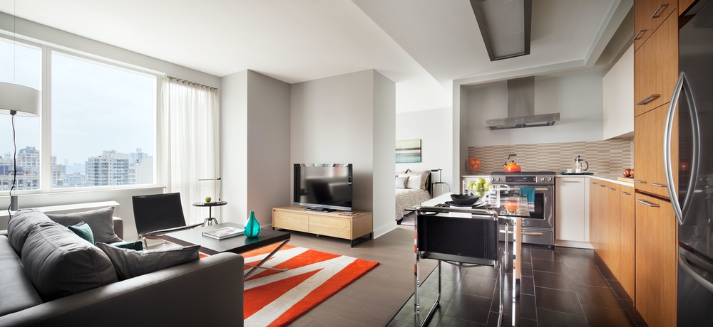 a living room with furniture wooden floor and a flat screen tv