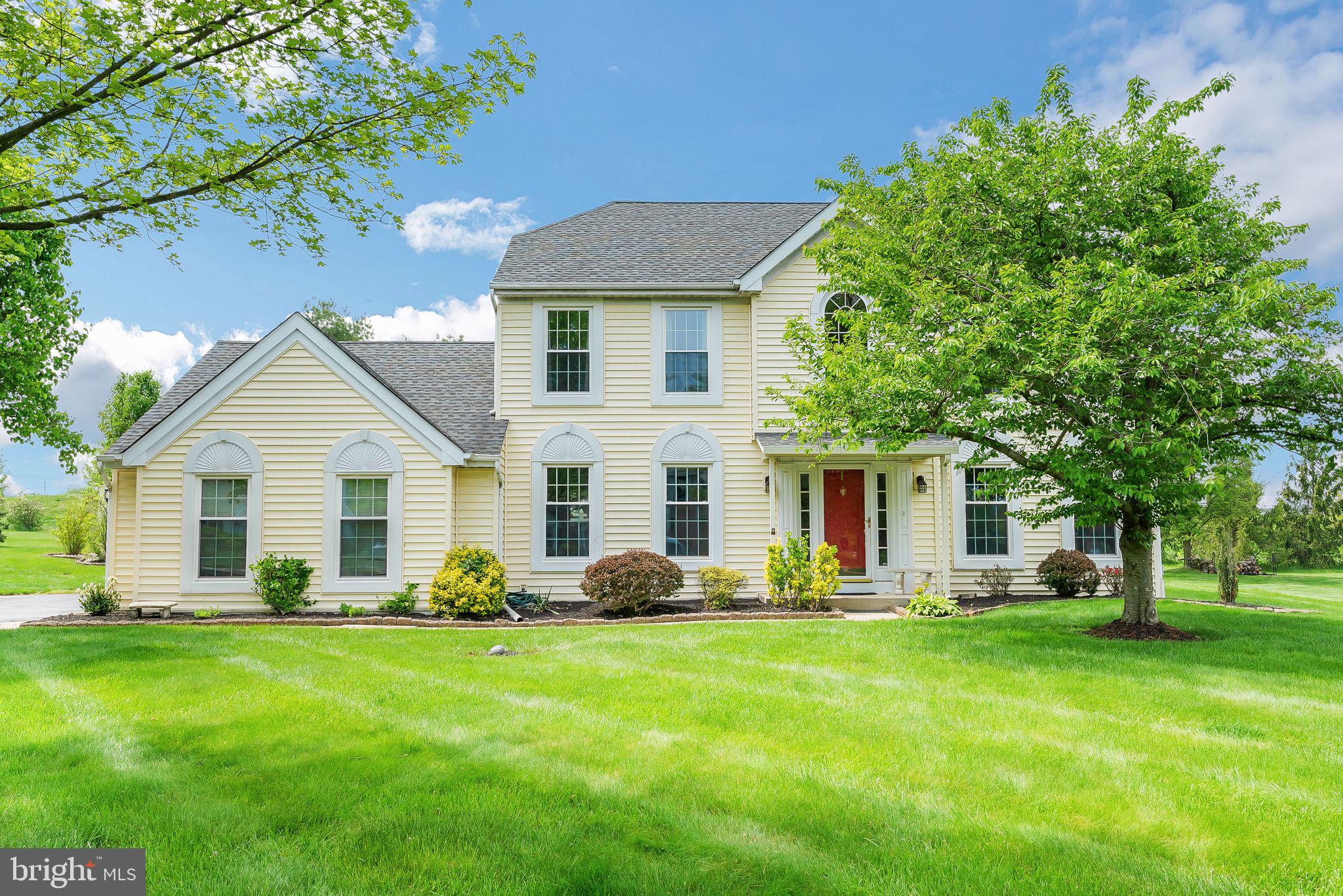 a front view of house with yard and green space