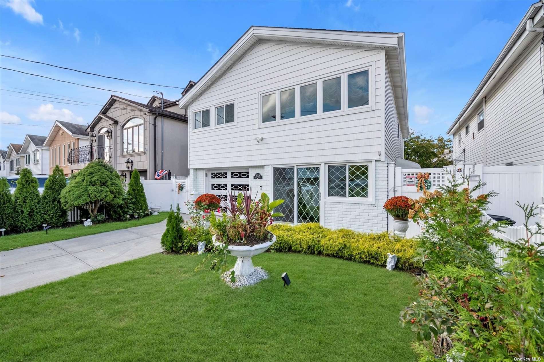 a front view of house with a garden and patio