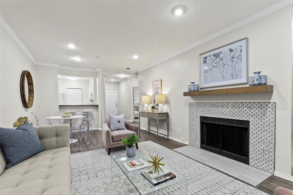 a living room with furniture a fireplace and a large mirror