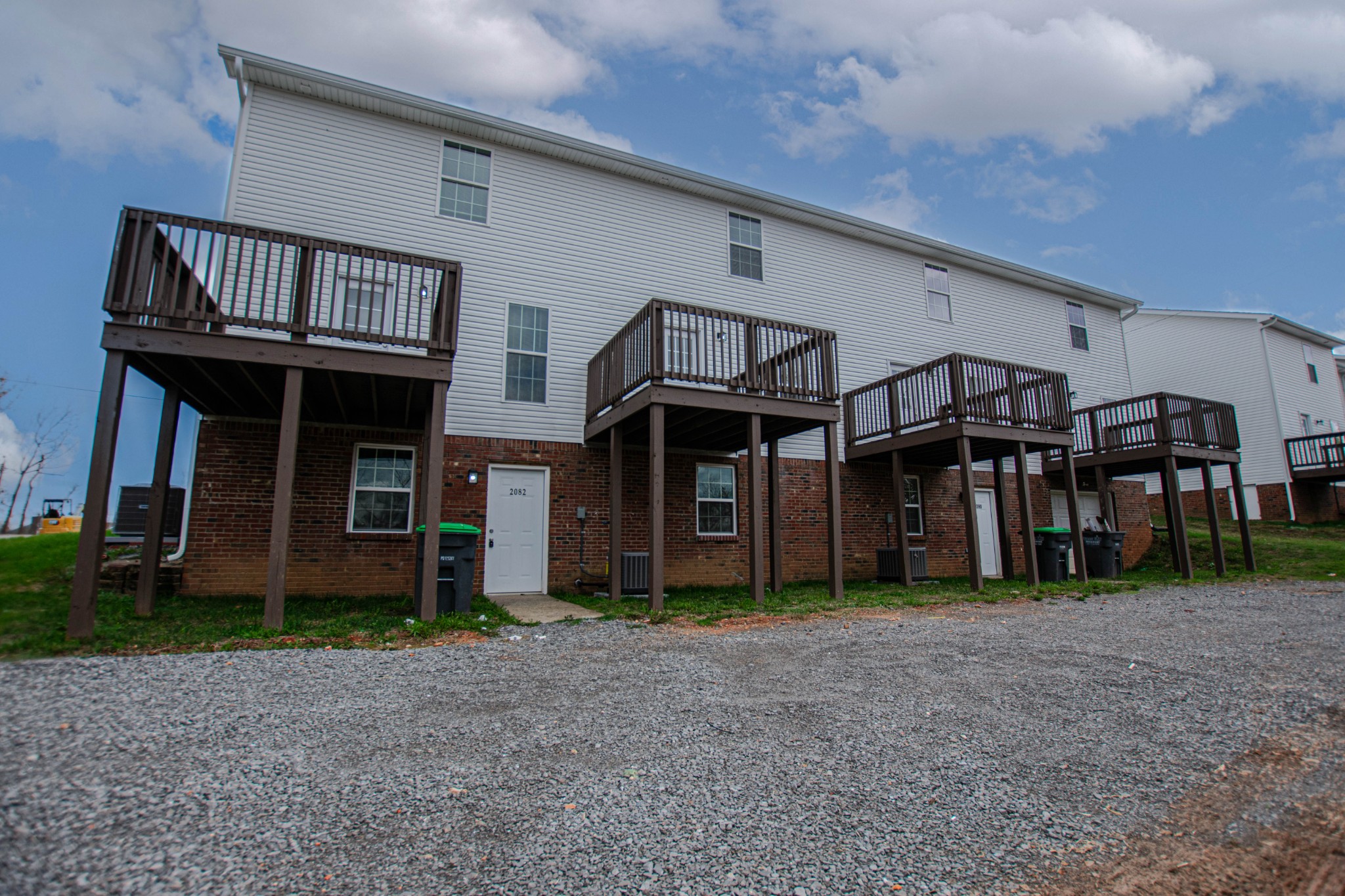 a view of a house with a deck and a yard