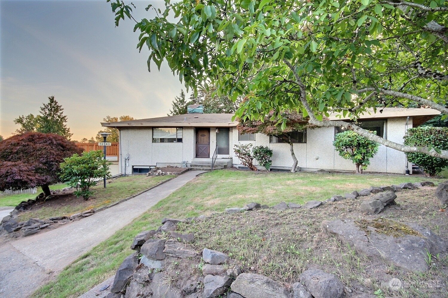 a front view of a house with garden