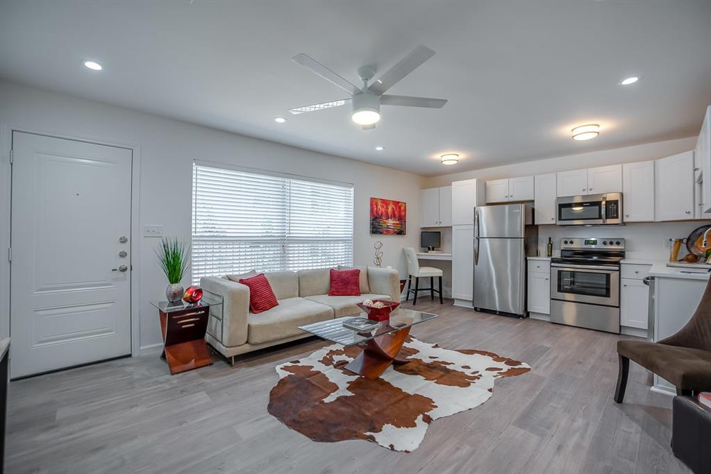 a living room with furniture and kitchen view