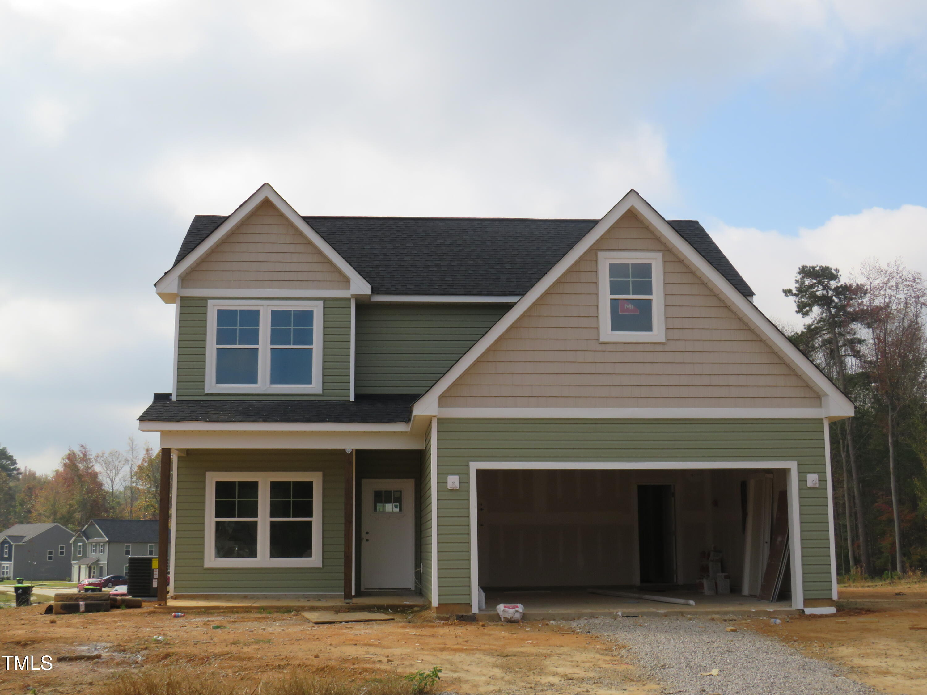 a front view of a house with garage