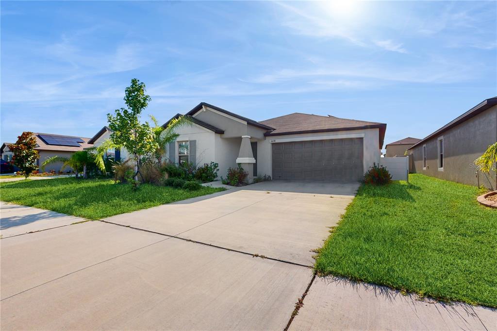 a front view of a house with a yard and garage