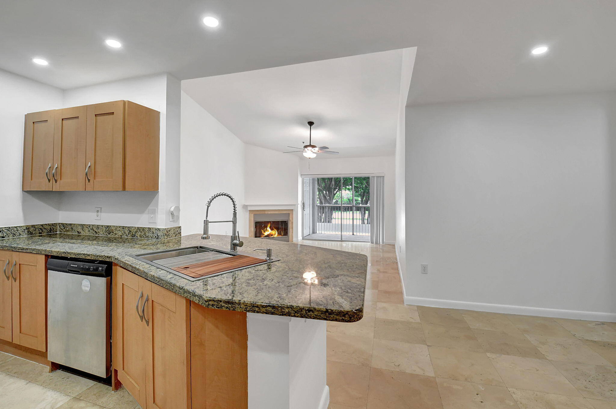 a kitchen with granite countertop a sink and cabinets