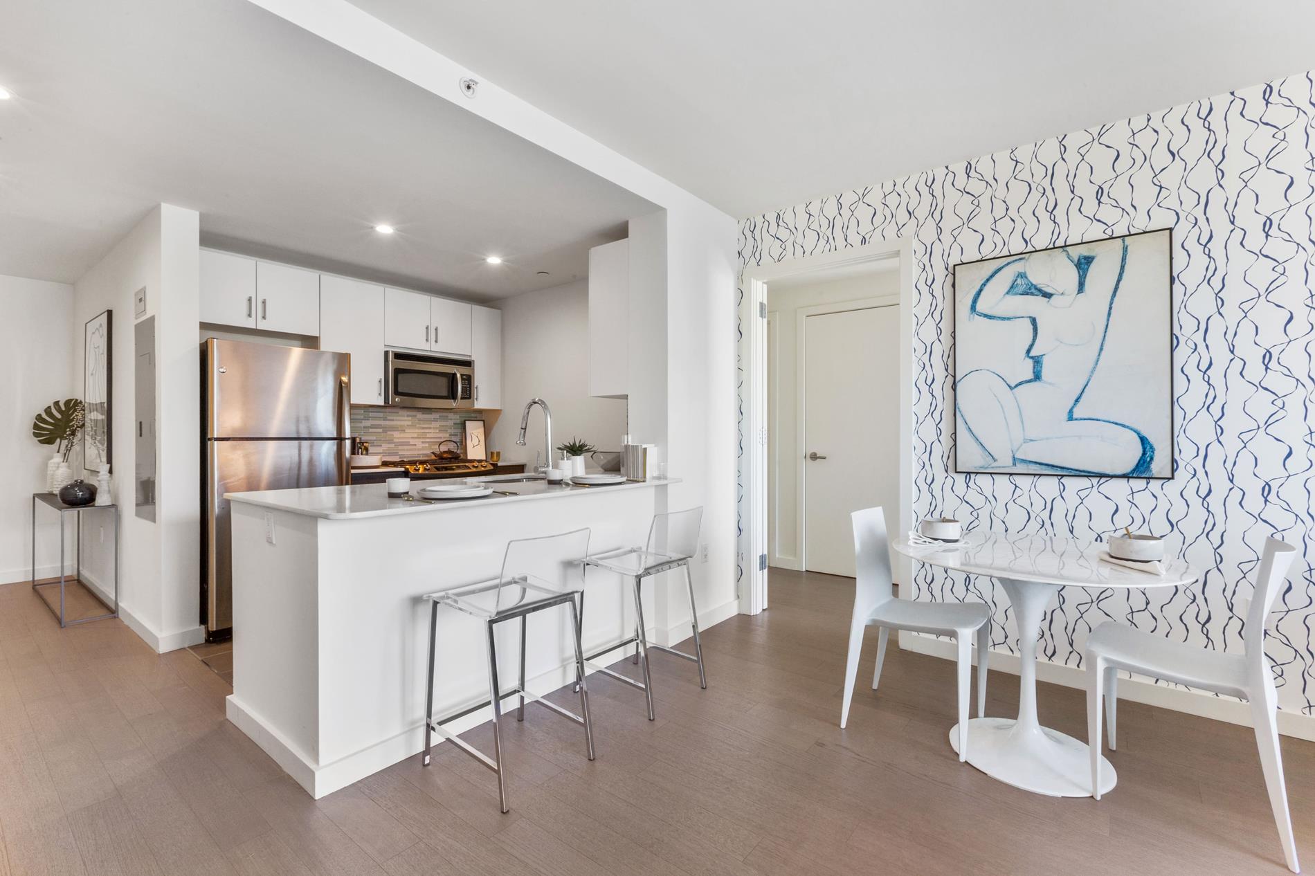 a kitchen with stainless steel appliances granite countertop a refrigerator and a stove top oven