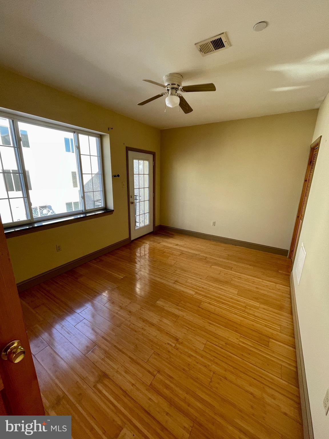 wooden floor in an empty room with a window