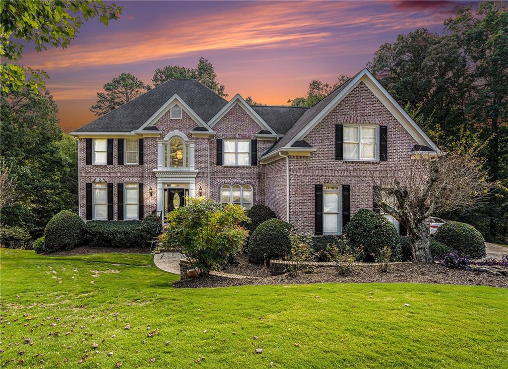 a front view of house with yard and green space