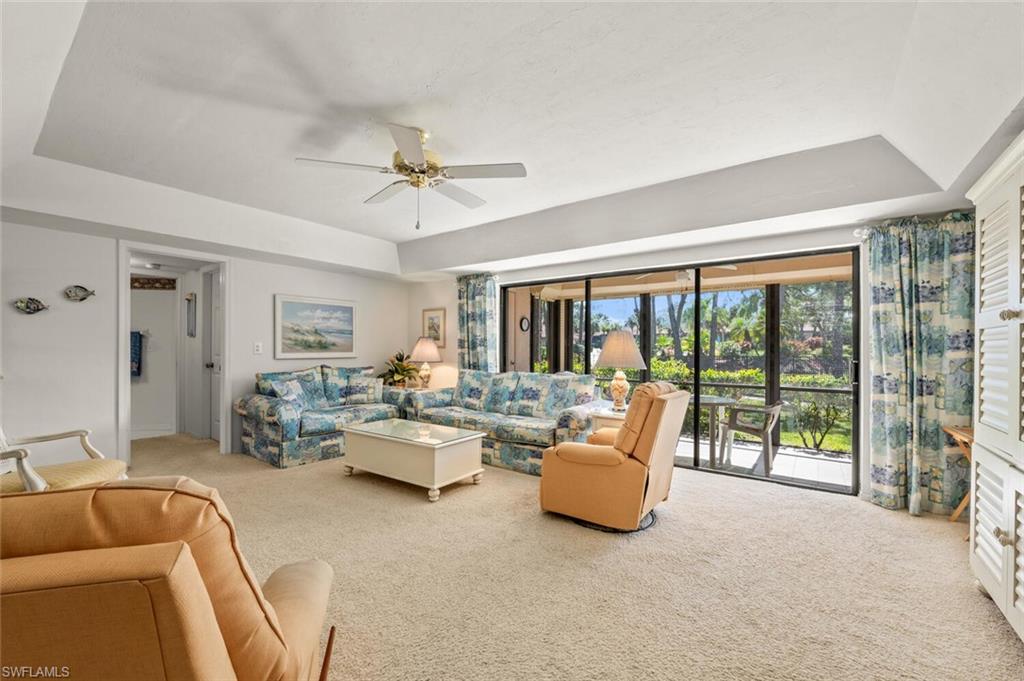 a living room with furniture and a floor to ceiling window