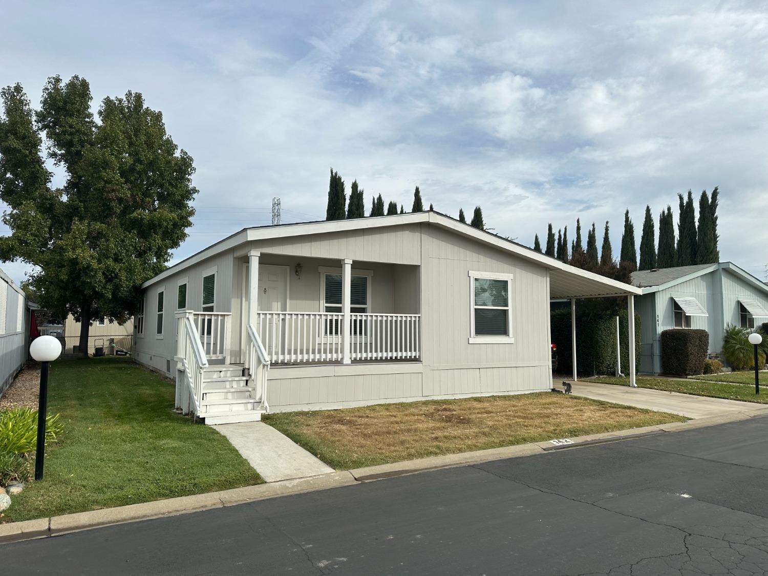 a front view of a house with a garden