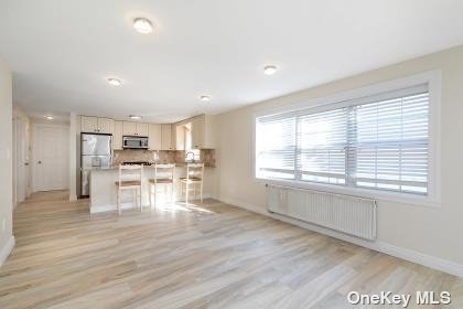 a view of kitchen with furniture and wooden floor