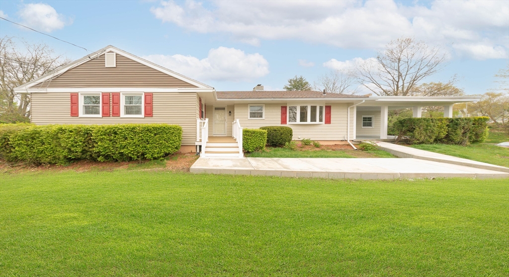 a front view of a house with a garden