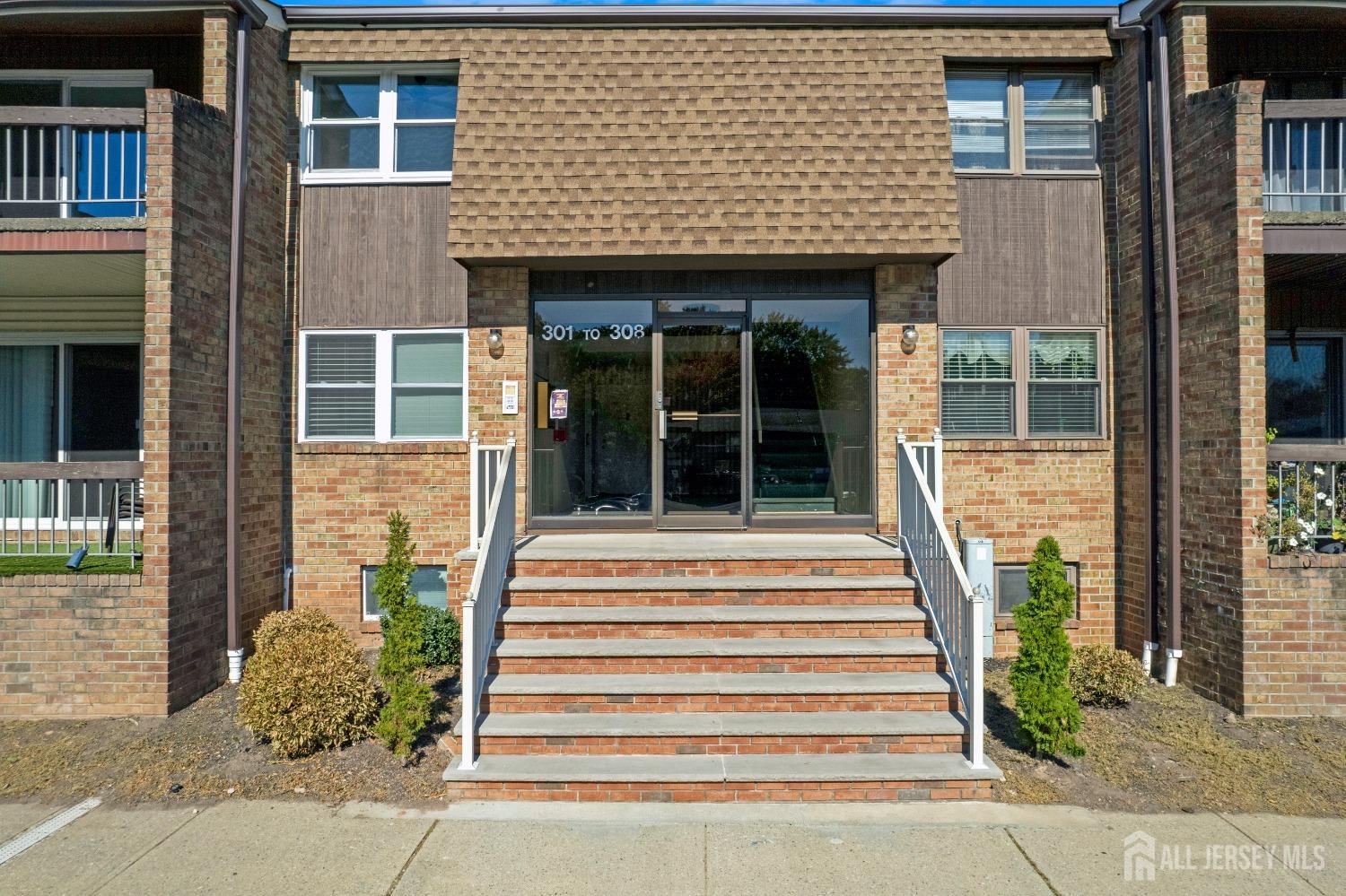 a front view of a house with a garden and plants