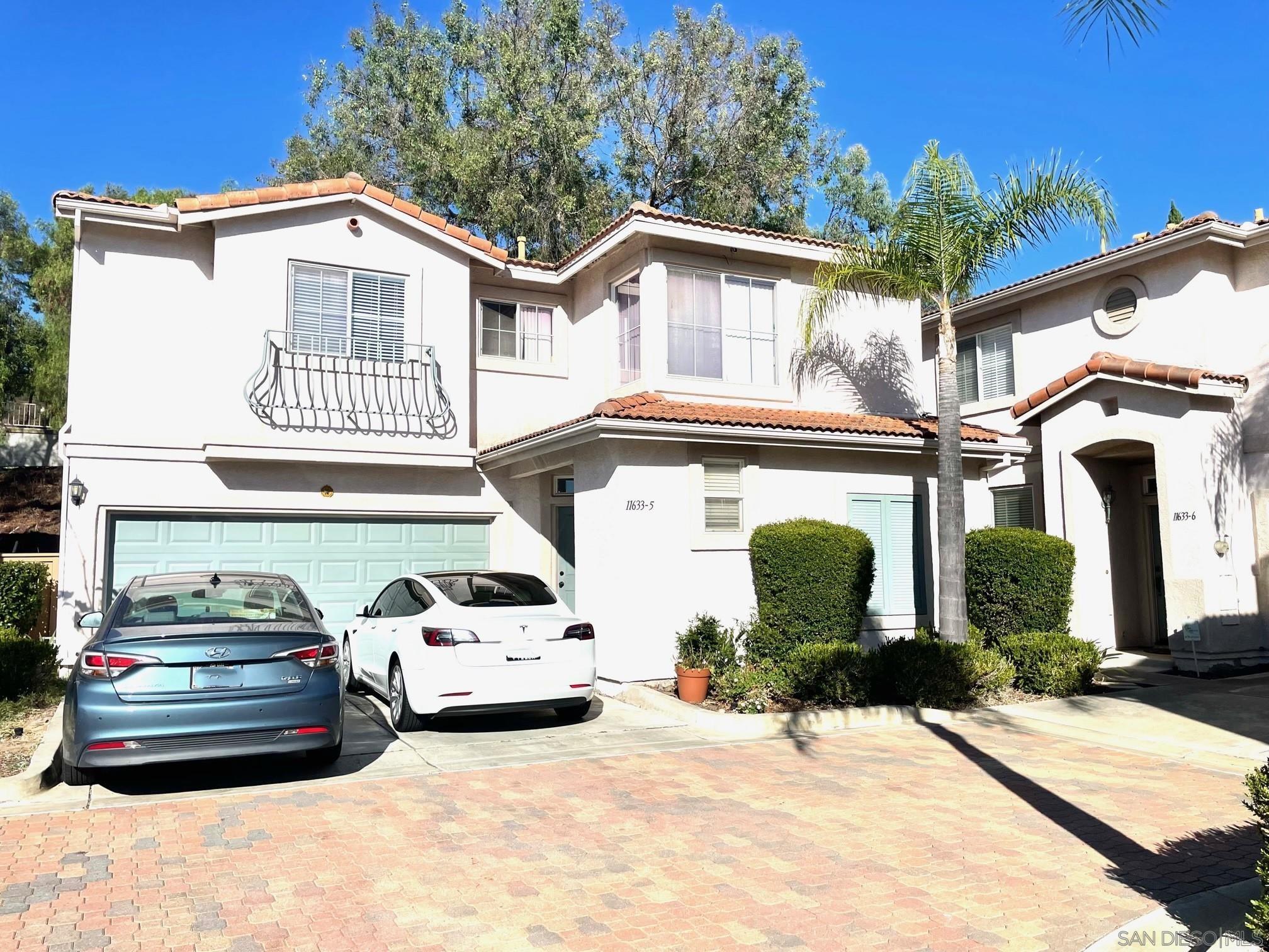 a front view of a house with parking space