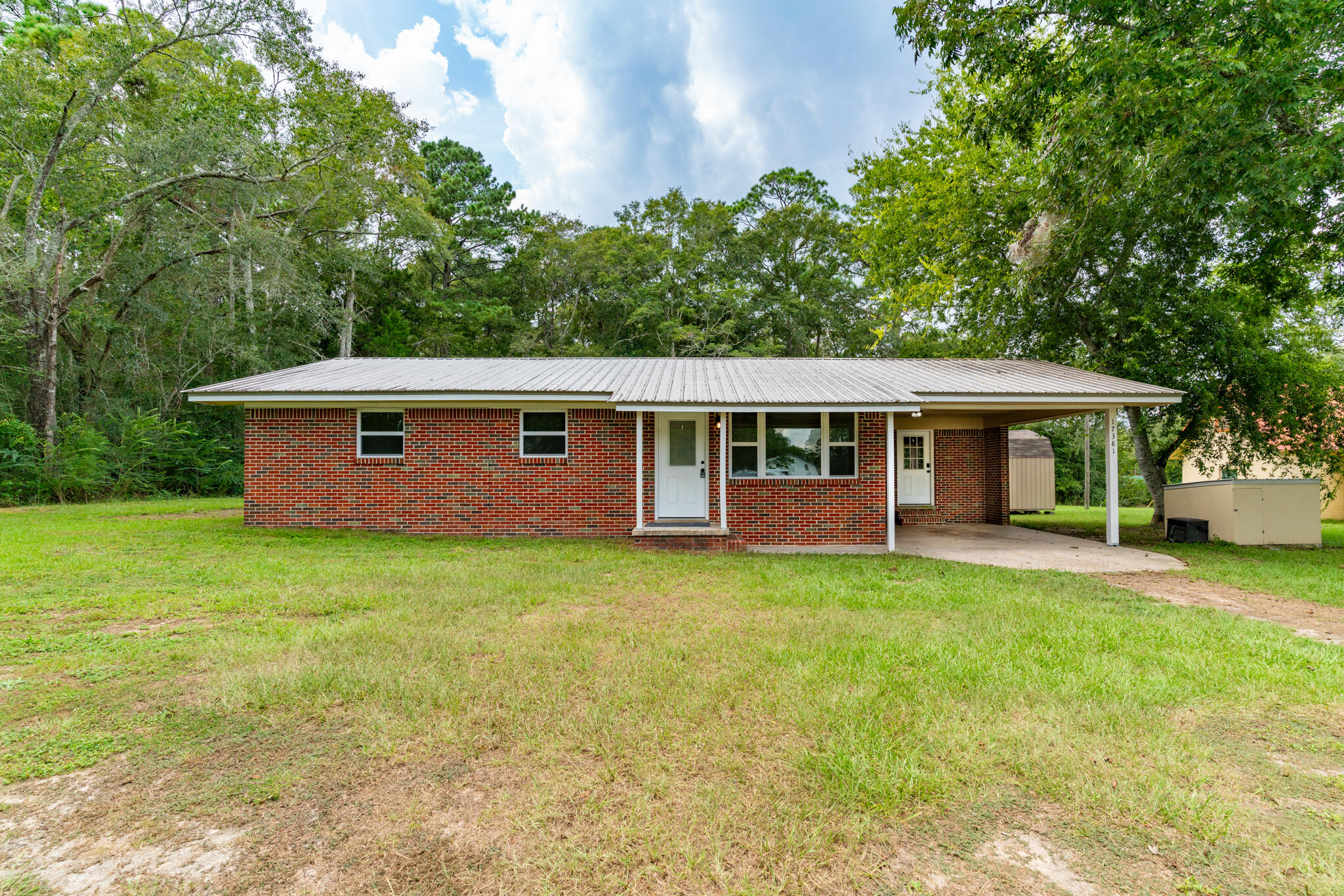 a view of house with backyard