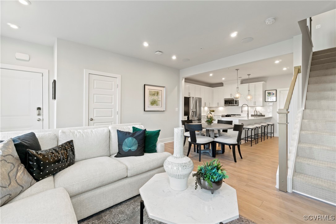 a living room with furniture kitchen view and a dining table