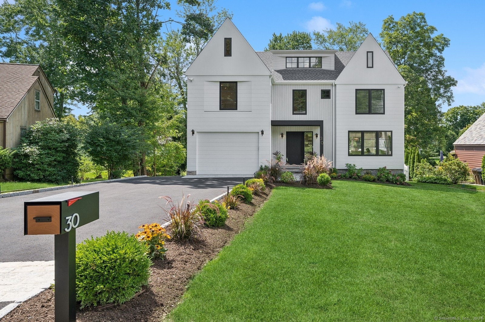 a front view of house with yard and green space