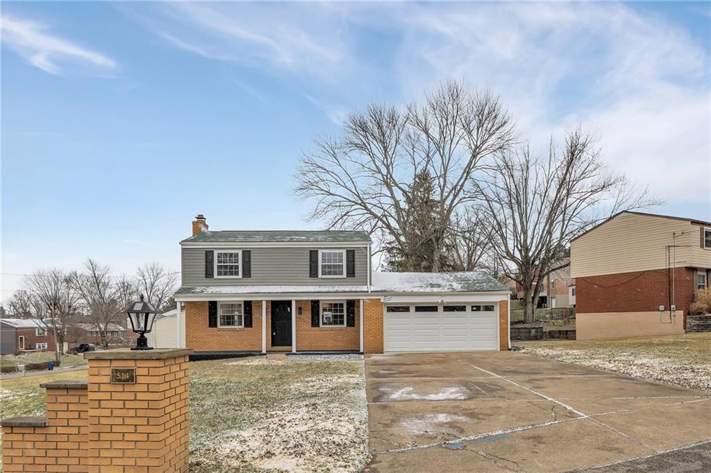 a house that has a tree in front of it