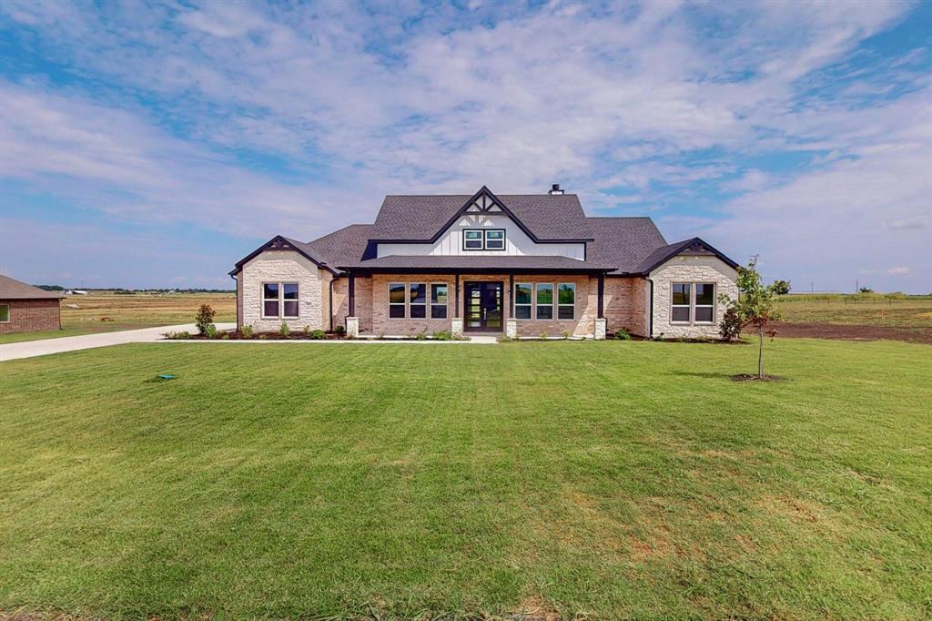 a front view of a house with a big yard