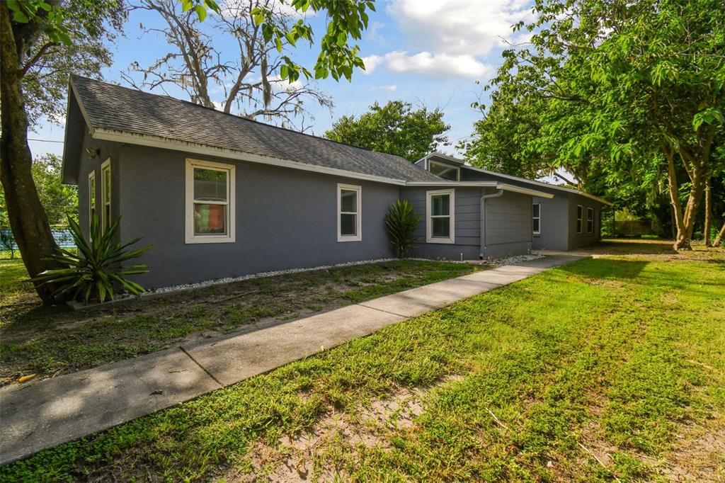 a front view of house with yard and green space