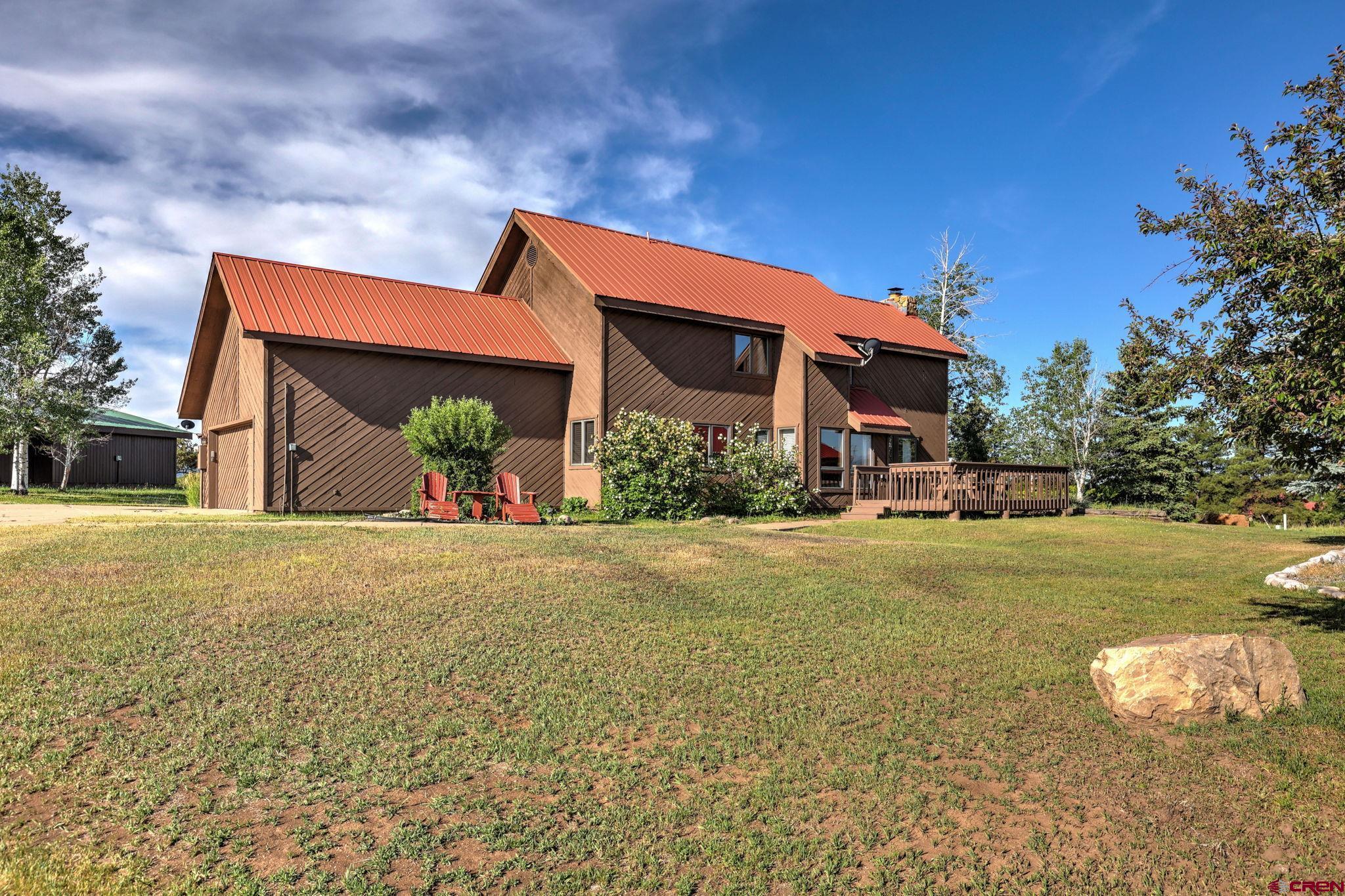 a front view of house with yard and outdoor seating